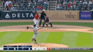 a baseball game is being played in front of a delta sign