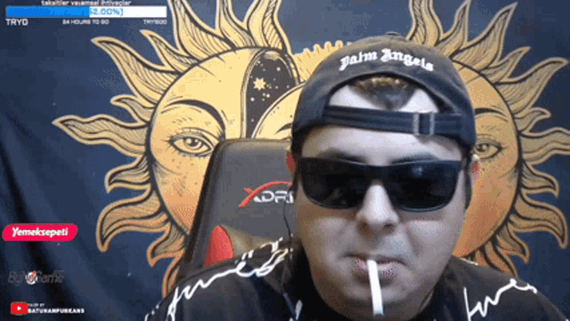 a man wearing sunglasses and a hat that says palm angels