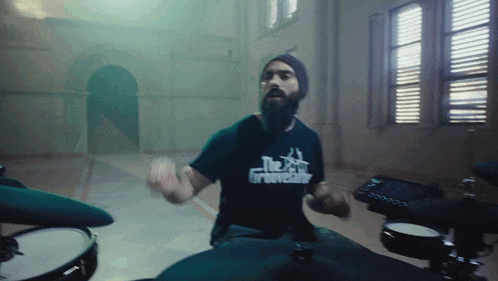 a man with a beard is wearing a shirt that says the godfather on it