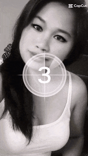 a black and white photo of a woman with a countdown of three seconds