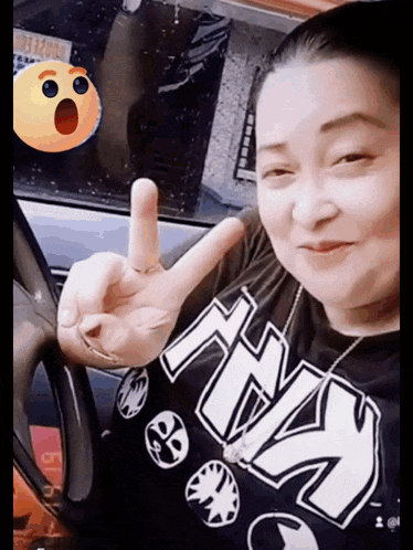 a woman wearing a t-shirt with the word ny on it giving a peace sign