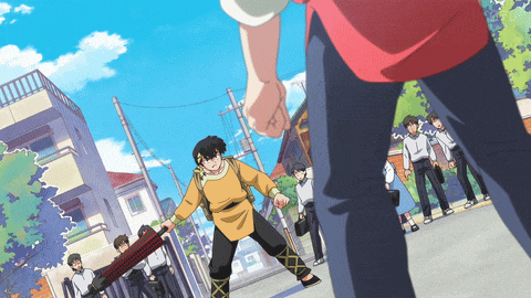 a group of people are walking down a street and one of them is holding a large sword