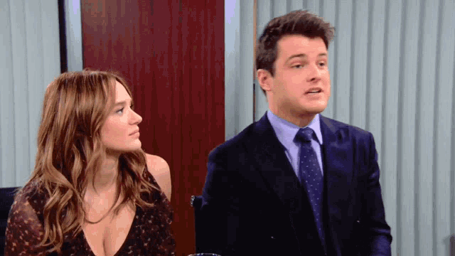 a man and a woman are looking at each other