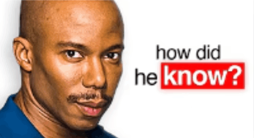 a bald man in a blue shirt is standing in front of a sign that says how did he know ?