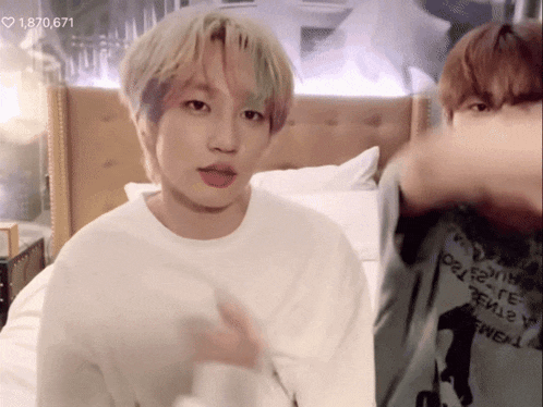 a man with blonde hair is wearing a white shirt with the number 1,870,671 on the bottom