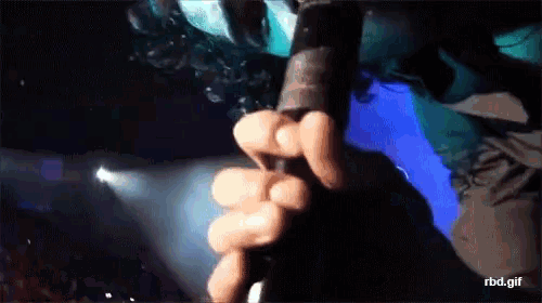 a close up of a person holding a microphone with the words rbd.gif below