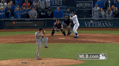 a baseball game is being played in front of a sign that says veterans