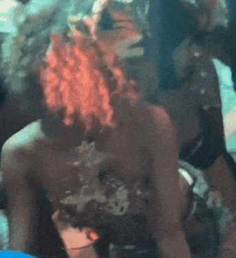 a woman in a leopard print top is surrounded by people