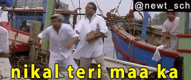 a group of men standing on a boat with the words nikal teri maa ka on the bottom