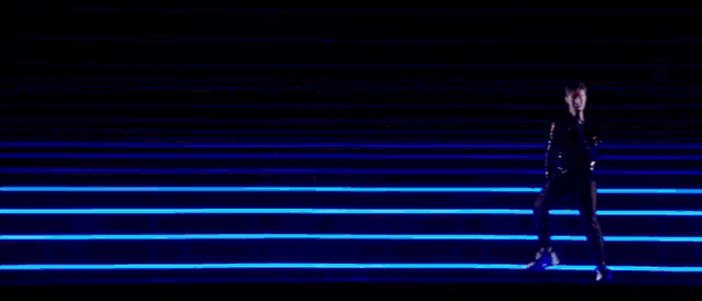a person is standing in front of a wall of lights .