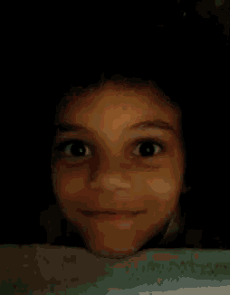 a close up of a doll 's mouth with a green shirt on .
