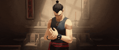 a man in a black tank top is standing in a room with chinese writing on the wall