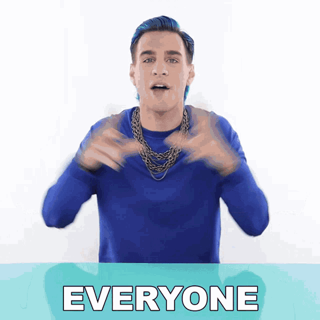 a man with blue hair and a necklace is standing in front of the word everyone