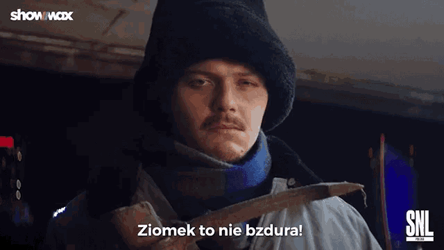 a man in a fur hat is holding a hammer and says ziomek to nie bzdura .