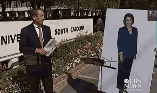 a man in a suit and tie stands in front of a sign that says south carolina