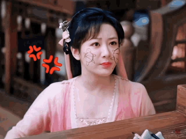 a woman in a pink dress has a drawing of a turtle on her face ..