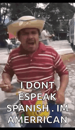 a man wearing a cowboy hat and a striped shirt says i dont speak spanish im american