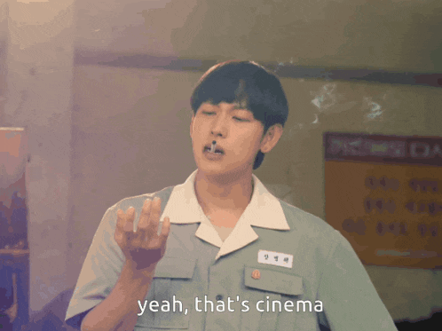a man smoking a cigarette with the words " yeah that 's cinema " below him