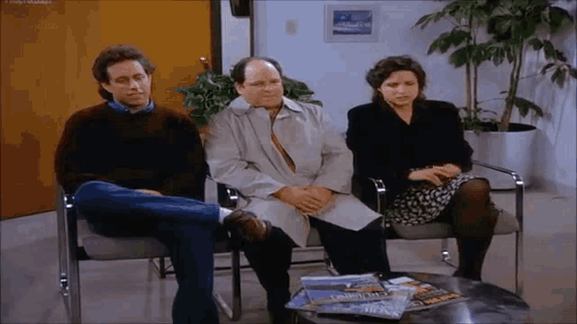 a group of people are sitting in chairs in a waiting room with magazines on a table .