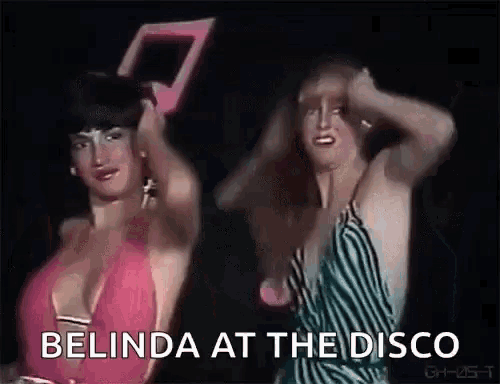 a couple of women are dancing in a club and the words belinda at the disco are visible .