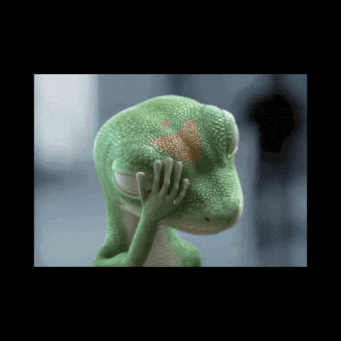 a green lizard with a red heart on its face