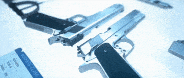 two guns and a business class ticket on a blue surface