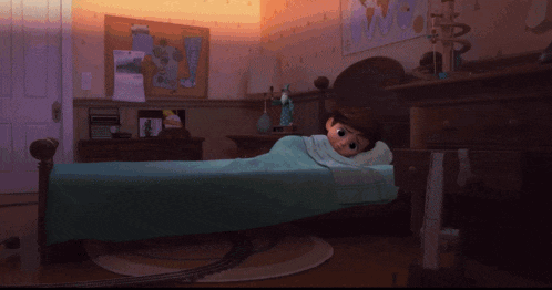 a child laying in bed with a blue blanket