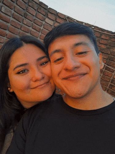 a man and a woman are posing for a picture