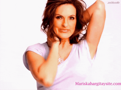 a woman in a white shirt with the website mariskahargitaysite.com in the corner