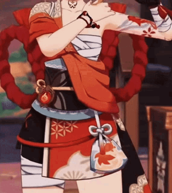 a woman in a red and black dress is holding a sword .