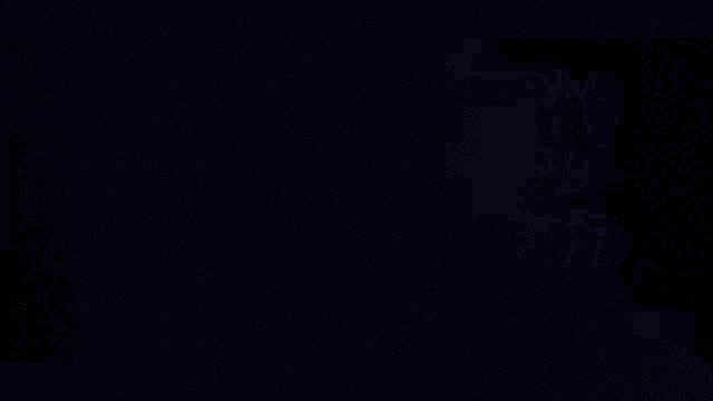 a person in a video game is holding a sword and a gun in a dark room .