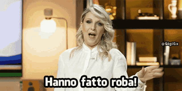 a woman says " hanno fatto roba " in front of a tv