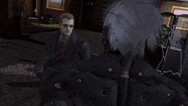 a man in a suit and tie is holding a glove that says tactical