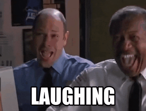two men are laughing while looking at a computer screen and the word laughing is above them