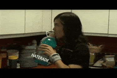 a man drinking from a bottle with the word haterade on it