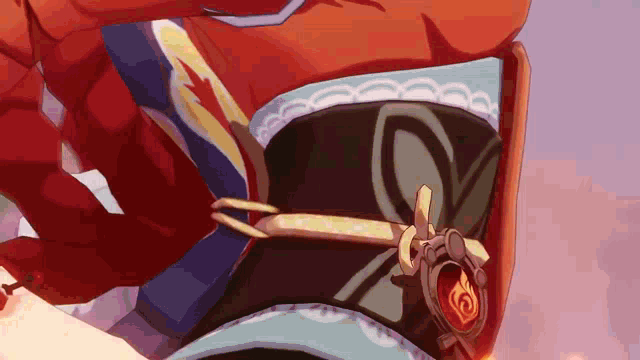 a close up of a cartoon character 's hat with a red flame on it