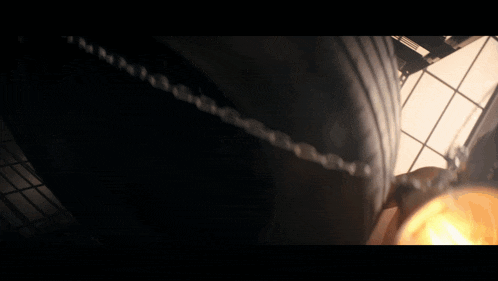 a close up of a light bulb with a woman behind it