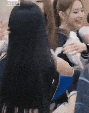 a group of young women are sitting next to each other .