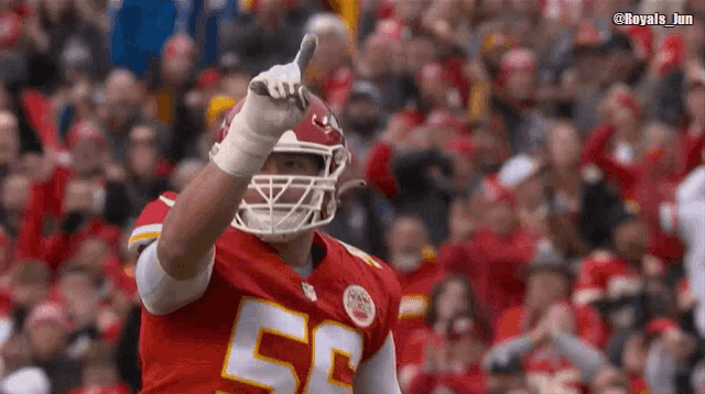 a football player with the number 55 on his jersey is giving a thumbs up