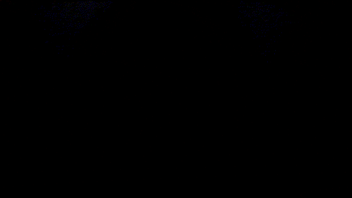 a person 's face is shown in a dark room