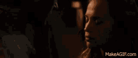 a man and a woman are kissing in the dark in a movie .