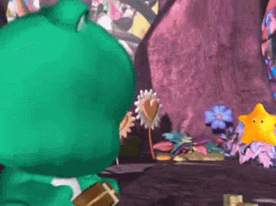 a green frog is sitting on a table next to a yellow star and flowers .