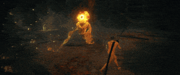 a naked man is holding a spear in front of a large fireball