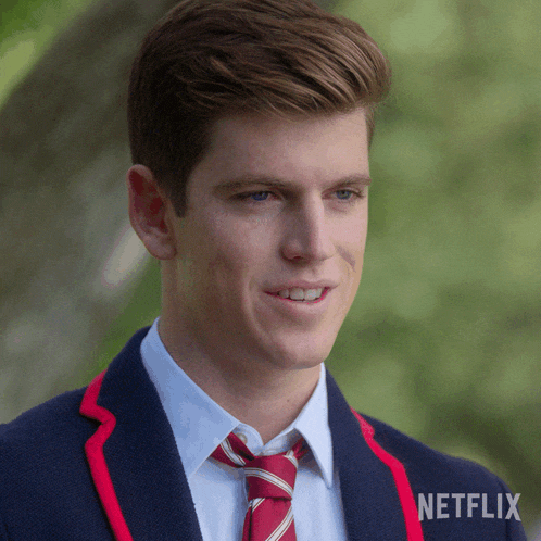 a man in a suit and tie with a netflix logo on the bottom right