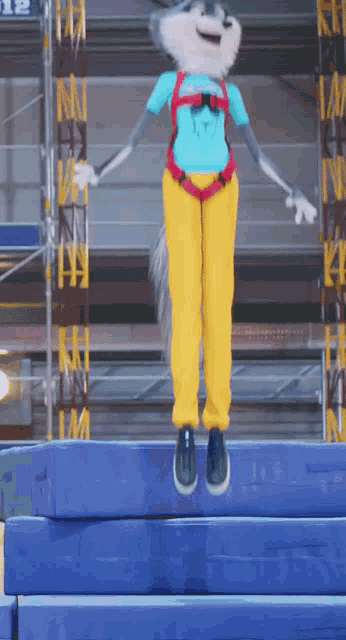 a mascot wearing a blue shirt and yellow pants is jumping