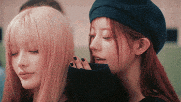 two women are standing next to each other and one has black nail polish on her nails