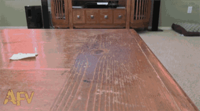 a wooden table in a living room with the letters afv above it
