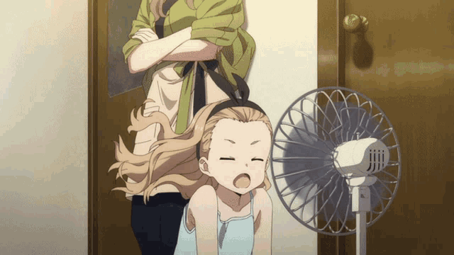 a girl is sitting in front of a fan and yawning