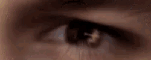 a close up of a person 's eye with a tear running down it .