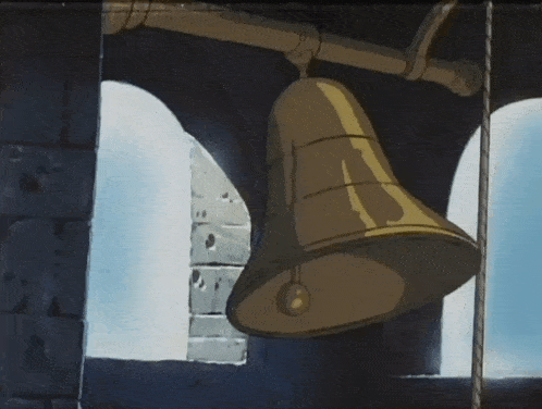 a large bell is hanging from a rope in a building